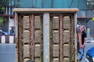 Old telephone switchboard with many wires.