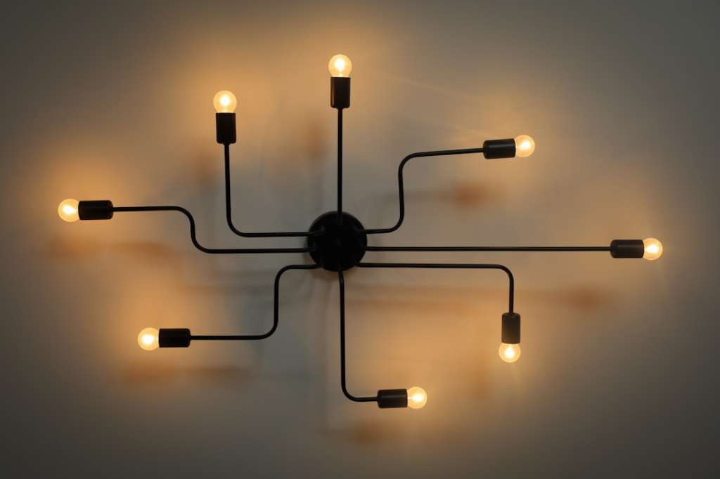 a wall mounted light fixture with five lights
