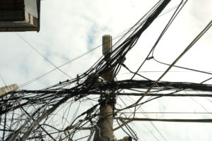 Tangled electrical wires on a utility pole