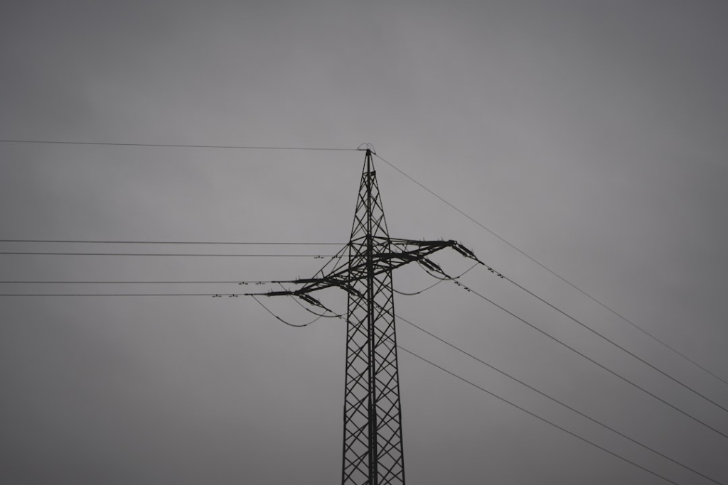 black electric post under gray sky
