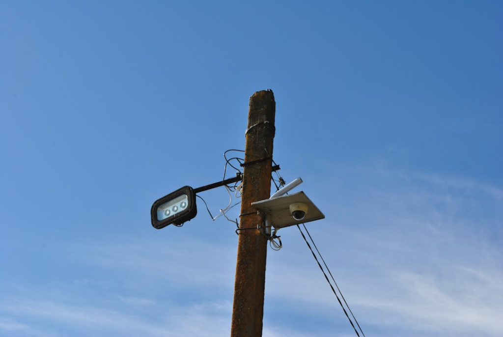 a telephone pole with a camera attached to it