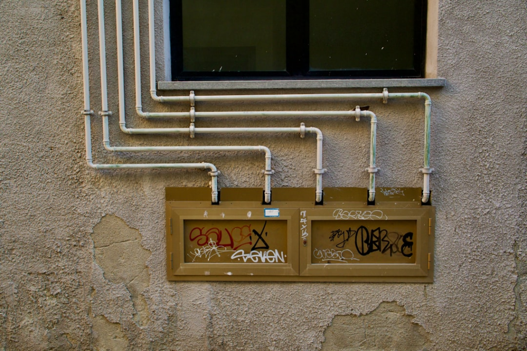 A wall with a bunch of pipes attached to it