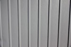 a close up of the side of a white fence