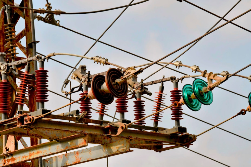 a bunch of wires that are hanging from a pole